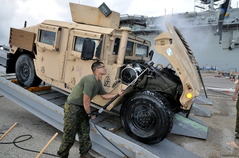 a soldier cleaning his humvy